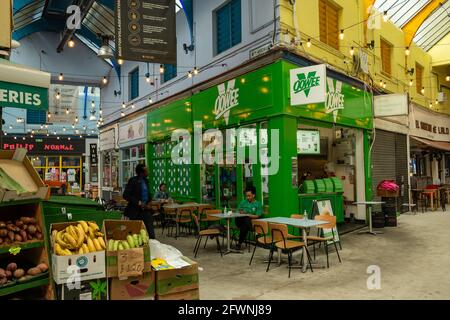 Brixton, London- May 2021: Inside Brixton Village which is part of Brixton Market- an indoor hall of world food stalls, bars and shops. Stock Photo