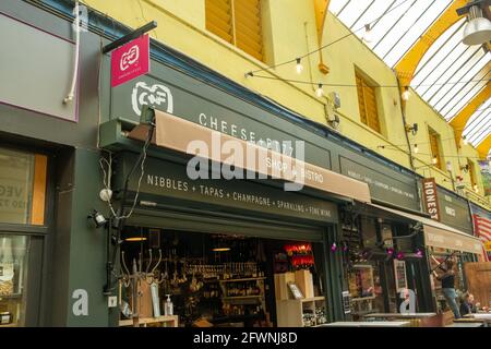 Brixton, London- May 2021: Inside Brixton Village which is part of Brixton Market- an indoor hall of world food stalls, bars and shops. Stock Photo