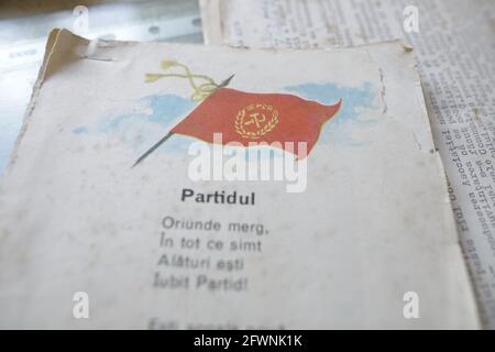 Marghia, Romania - May 5, 2021: Shallow depth of field (selective focus) details with a Romanian Communist Party flag and nationalistic poem in an old Stock Photo