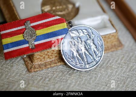 Marghia, Romania - May 5, 2021: Shallow depth of field (selective focus) details with old Communist award medal. Stock Photo