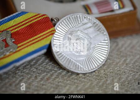 Marghia, Romania - May 5, 2021: Shallow depth of field (selective focus) details with old Communist award medal. Stock Photo