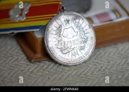 Marghia, Romania - May 5, 2021: Shallow depth of field (selective focus) details with old Communist award medal. Stock Photo