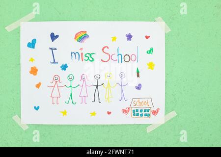 Child holding I miss School message on paper. Sadness in homeschooling during covid-19 pandemic concept. Stock Photo