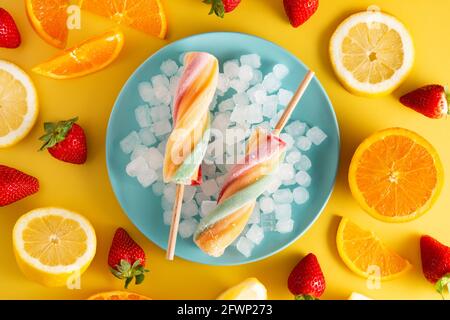 Spiral colorful popsicle on yellow background Stock Photo