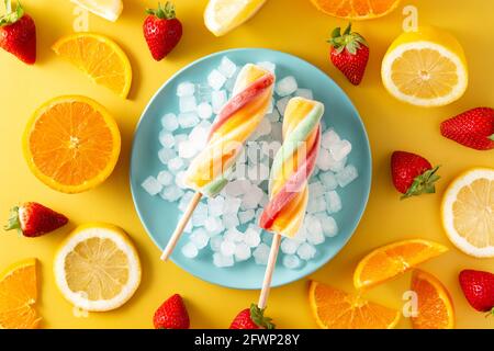 Spiral colorful popsicle on yellow background Stock Photo