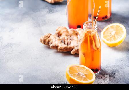 Blueberries, Cranberries Fermented Raw Kombucha Vegan Drink With Ginger And Lemon In Bottle With Eco-friendly Straw Stock Photo