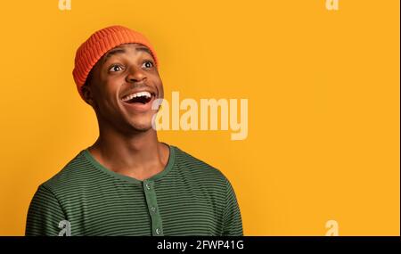 Wow. Portrait Of Amazed Black Hipster Guy Looking Away With Excitement Stock Photo