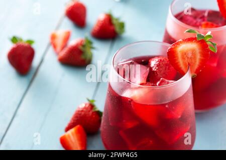 Strawberry cocktail in glass on blue wooden table Stock Photo