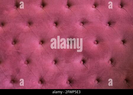 The upholstery is suede of the burgundy sofa. Fabric red suede background. Stock Photo