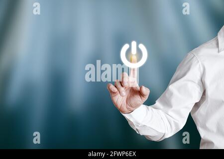 Male hand pressing standby icon on a virtual display screen. Stock Photo