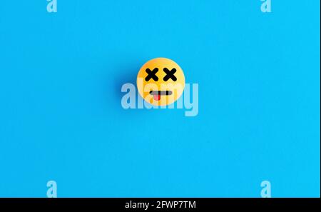 Dead face emoticon or icon on a ball on blue background. Missing web page, link or file problem. Stock Photo