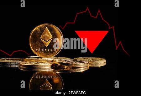 Crypto collapse. Golden coin with Ethereum logo drop at bear market. Pullback of cryptocurrency Ethereum ETH in trading. Decentralized digital Stock Photo