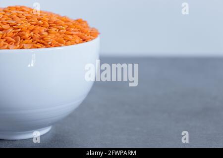 Dhal beans in a white shiny ceramic bowl close up. Stock Photo
