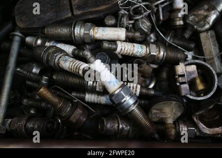 Kuwait City – Kuwait – April 15, 2021: Used and discarded auto spark plugs Stock Photo