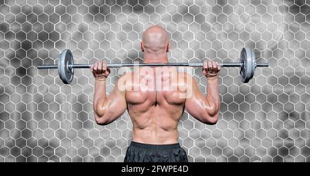 Composition of rear view of muscular man lifting weights with hexagons on grey background Stock Photo