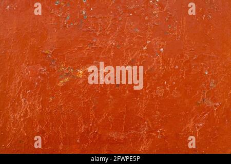 Old red dirty grunge painted stucco wall background Stock Photo