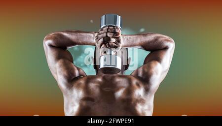 Composition of rear view of muscular strong african american man lifting dumbbells Stock Photo