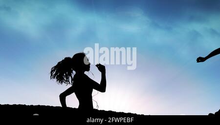 Composition of silhouette of fit woman running against clouds on blue sky Stock Photo