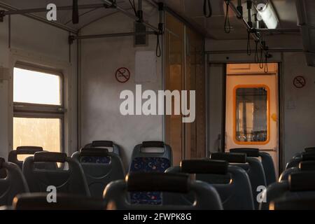 Picture of a typical seat from a European train, empty, en route on a suburban route typical from Europe, in an old  EMU train. Stock Photo