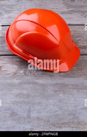 Industrial protective helmet on wooden background. Stock Photo