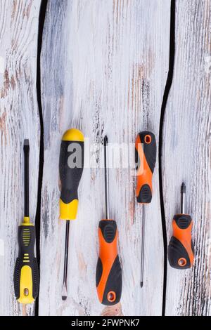 Set of screwdrivers on wooden background. Stock Photo