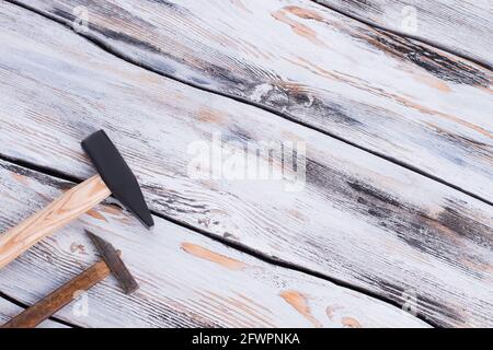 Two hammers on wooden surface. Stock Photo