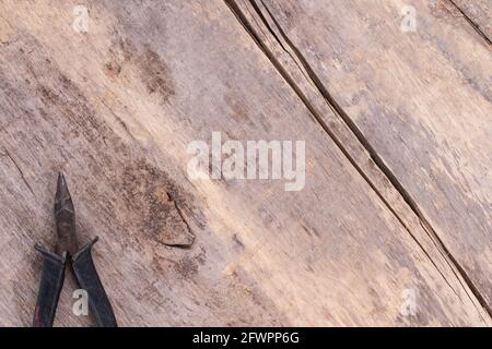 Old pliers with rubber handle on rustic wood. Stock Photo