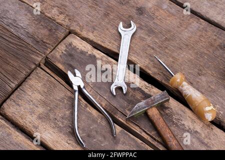 Used construction tools on old wooden boards. Stock Photo