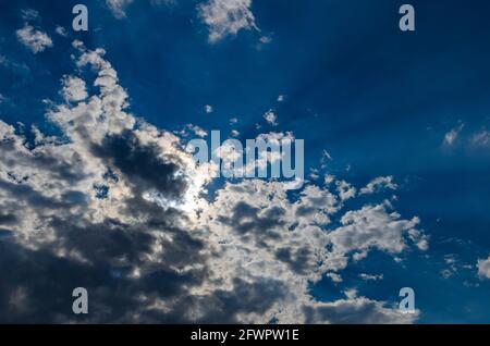 Summer sun hidden behind the clouds Stock Photo