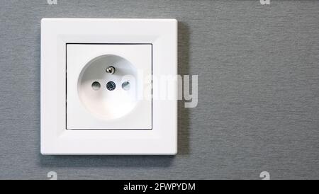 Closeup of classic European power, electric wall outlet switch, socket. White EU electric socket. Stock Photo