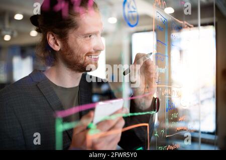 Programmer working and developing software in office Stock Photo