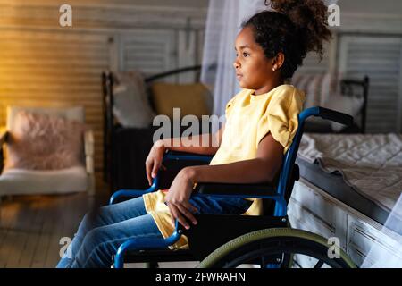 Portrait of disabled black girl with wheelchair at home Stock Photo