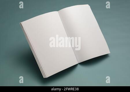 Composition of opened book with blank pages on blue background Stock Photo