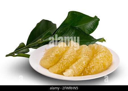 Pomelo flesh in a white dish and leaves on white background with clipping path. Stock Photo