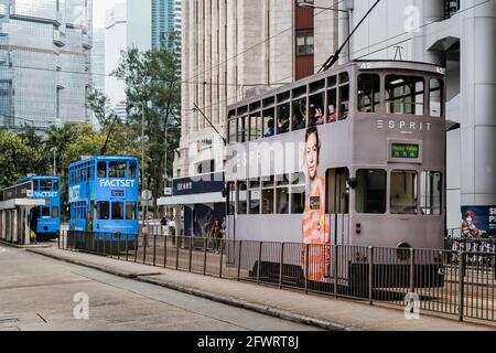 Grey and blue double decker electric trams at Bank Street stop in Hong Kong on 21 March 2012 Stock Photo