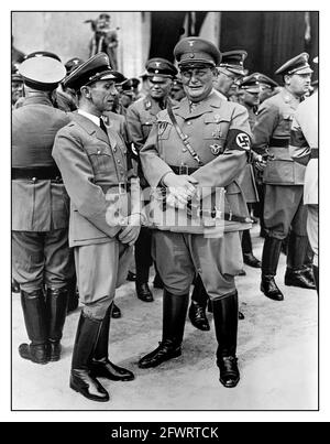 1930s Propaganda Nazi photo of Dr Joseph Goebbels and Hermann Goering in uniform with jackboots wearing Swastika armbands standing together with other high ranking officers of the Nazi Party. Germany, 1936. Stock Photo