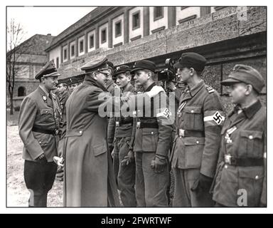 HITLER LAST DAYS 1945 One of the last public appearances and images of Adolf Hitler meeting and awarding Iron Cross medals to his fiercely loyal brave (deluded) Hitler Youth members April 1945 WW2 World War II Battle for Berlin against an advancing Soviet Army Stock Photo