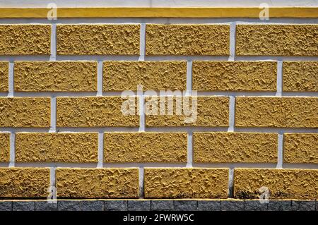 Decorative wall with textured yellow bricks Stock Photo