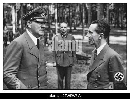 Adolf Hitler &  Reichminister Dr Joseph Goebbels with Nazi swastika armband at the Wolf’s Lair Headquarters.Poland. Hitler and Goebbels at the Wolf's Lair shortly after the beginning of Operation Barbarossa, 1941 The Wolf's Lair (German: Wolfsschanze; Polish: Wilczy Szaniec) was Adolf Hitler's first Eastern Front military headquarters in World War II. The complex, which became one of several Führerhauptquartiere (Führer Headquarters) in various parts of Central and Eastern Europe, was built for the start of Operation Barbarossa—the invasion of the Soviet Union—in 1941. Stock Photo