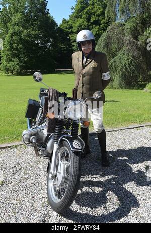 Varese, Italy. 24th May, 2021. Varese, Italy Distinguished Gentleman's Ride world event gathering of motorcyclists of both sexes dressed in vintage and current style in Varese at Villa Ponti In the photo: motorcyclist with his motorcycle Credit: Independent Photo Agency/Alamy Live News Stock Photo
