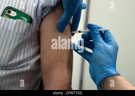 Tokyo, Japan. 24th May, 2021. A pensioner receives the Moderna coronavirus vaccine at the newly-opened mass vaccination centre. With one of the lowest Covid-19 vaccination rates in the developed world and with the Tokyo Olympic Games little over two months away, Japanese authorities have opened mass vaccination sites in Tokyo and Osaka in an effort to boost their coronavirus inoculation campaign. Credit: Carl Court-POOL/ZUMA Wire/Alamy Live News Stock Photo