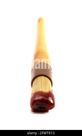 Wooden Culinary Brush Dipped in Barbecue Sauce Isolated on a White Background Stock Photo