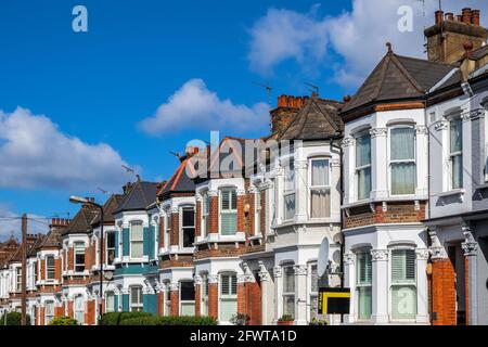 A row of typical British terraced houses around Kensal Rise in London with an estate agent sign Stock Photo
