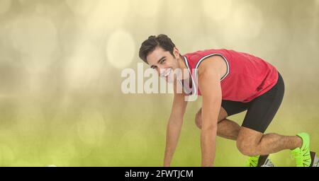 Composition of athletic man preparing before running on green background Stock Photo