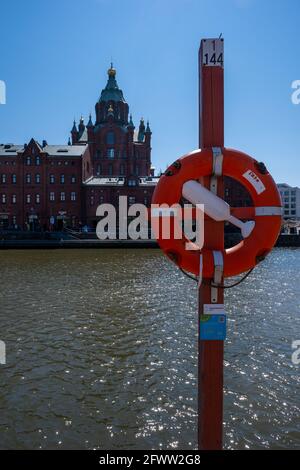 Helsinki / Finland - MAY 22, 2021: Skyline of the Helsinki downtown district with the Uspensky Cathedral in the background. Stock Photo