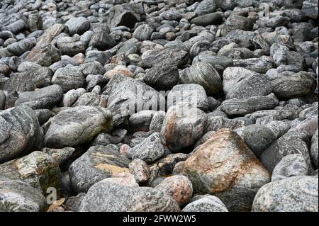 Abstract many large grey rocks, smooth and patterned texture. Authentic, on beach on Isle of Lewis, Outer Hebrides, Scotland Stock Photo