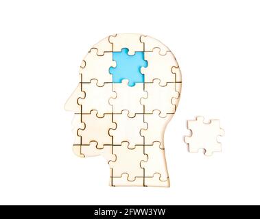 Human head profile shaped jigsaw puzzle with the final piece to be set in place isolated on white. Business idea and expertise implementation concept. Stock Photo