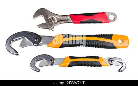Set of metal hand tools for tightening nut or bolt. Closeup of adjustable wrench with red grip or two self-adjusting spanners with yellow black handle. Stock Photo