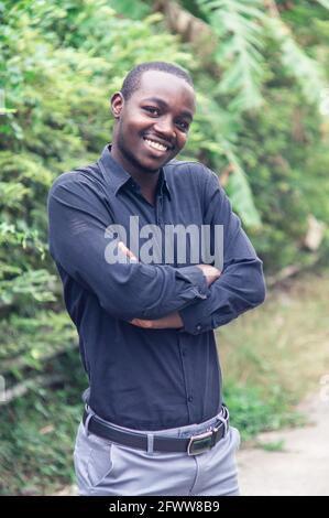 A charming, friendly african man who stands smiling and shows sincere respect Stock Photo