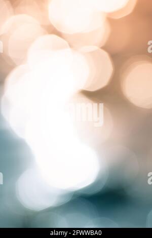 Bokeh shapes and shadows on water surfaces on the coast creating texture and patterned backgrounds and backdrops. Stock Photo